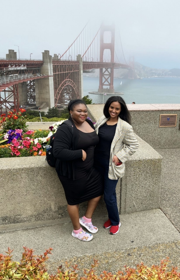 Anastasia and friend stand in front of Golden Gate view